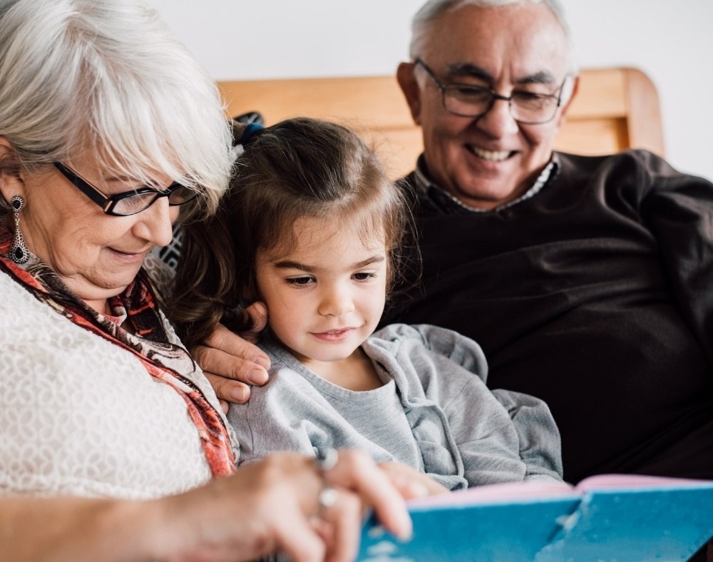 Family member reading a book with a person who has dementia