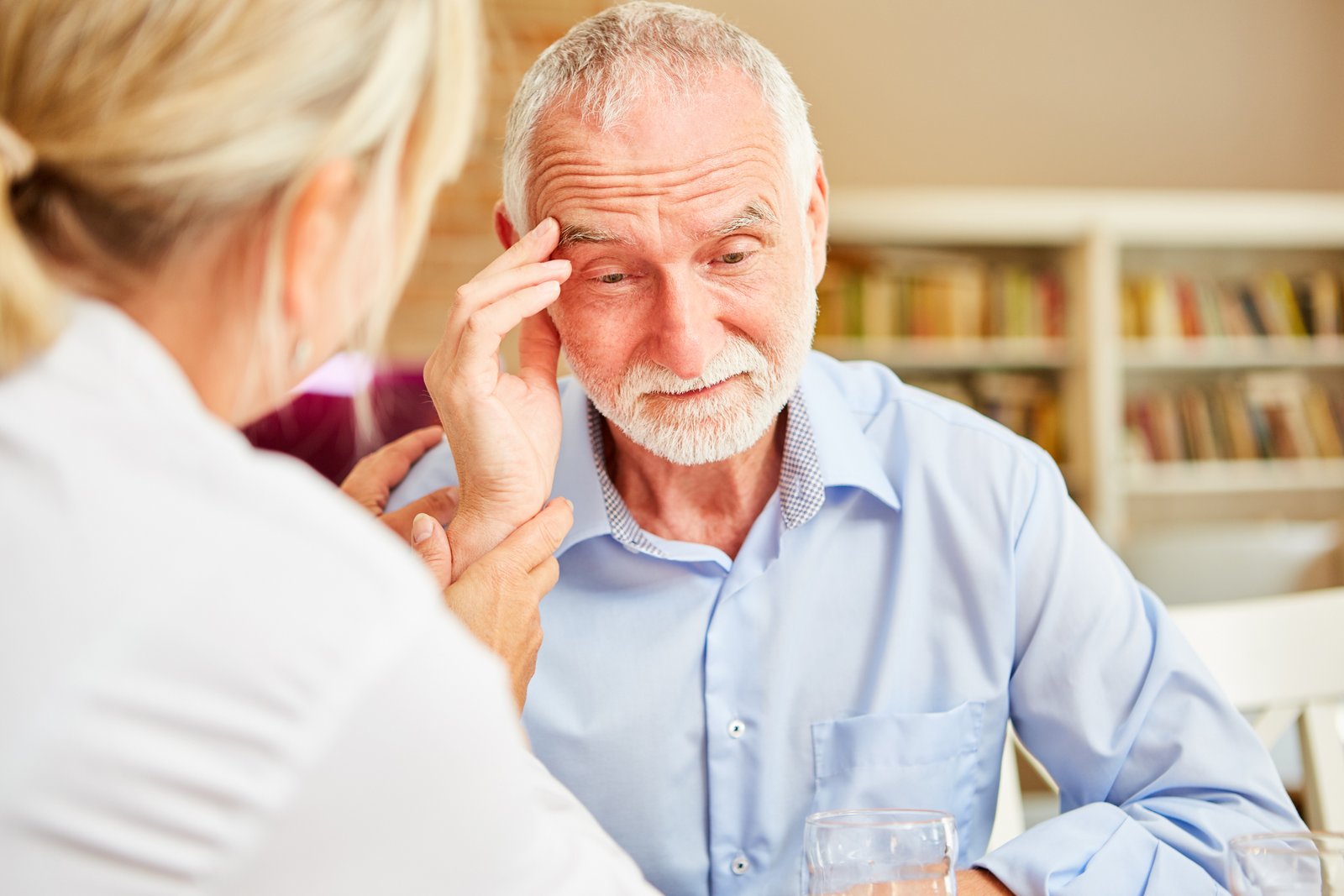 Doctor discussing memory concerns and treatment options with an older patient and family member